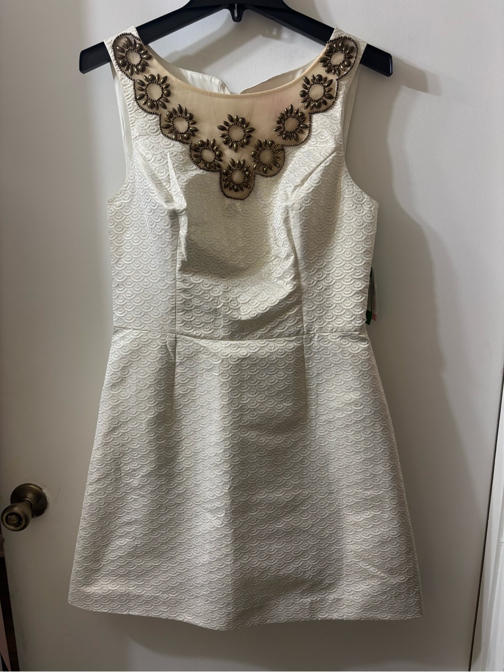 Sleeveless Cream Textured Fit-and-Flare Dress with Embellished Neckline